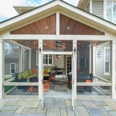 an outdoor living area with glass doors and patio furniture