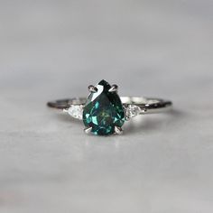 STONE NAME  :- TEAL SAPPHIRE(LAB-CREATED) STONE DIMENSION :-  7.9*MM SIDE STONE :- AMERICAN DIAMOND STONE SETTING :- PRONG STONE COLOUR :- GREEN  STONE CUT :- PEAR PAYMENT - We are accept all payment methods. RETURN - if you are not satisfied with our product, you may return your order within 7 days from the date of shipment received. The item must be returned in its original condition With Original Packing. Shipping charges are not refundable and Return Shipping Charges Will Also Be Borne By Buyer. FEEDBACK - Your Feedback is very Important for us. If you have any problem regarding packaging or product, kindly contact us to resolve the issue before leaving Negative Feedback... We Try to Give Our Customer The Best Quality. NOTE - There May Be Little Variation In Colour Between Image And Ac Teal Sapphire Ring, Wedding Ring Women, Saphir Ring, Teal Sapphire, Stone Colour, Bridal Wedding Rings, Etsy Personalized Gifts, Stone Setting, Women Ring