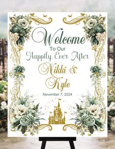 a welcome sign with flowers and a castle in the background for a wedding or other event