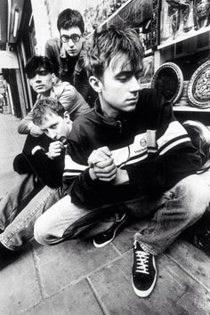 black and white photograph of boys sitting on the ground