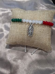 Handmade adjustable bracelet - material is nylon so one of things that are important is to keep it away from water as it can come undone  - Mexico flag themed colors & a silver virgencita charm 💕 - the perfect bracelet for you, for him, or for her 🫶 Adjustable Silver Bohemian Rosary Bracelet, Adjustable White Bracelet Souvenir, Adjustable Spiritual Bracelets With Charms, Adjustable Rosary Bracelet With Charms As Gift, Adjustable Rosary Bracelet With Charms For Gift, Mexican Bracelets Handmade, Mexico Bracelets, Mexican Bracelets, Bracelet Business