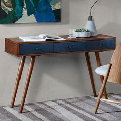 48" wide x 16" deep x 30" high. Weighs 59.47 lbs. Three-drawer Mid-Century Modern rectangular wood writing desk from the Howard collection by Madison Park. Warm pecan finish over rubberwood, MDF and oak veneer top construction. Navy blue finish drawer front. Bronze pull knobs. Includes three drawers. Desk top is 48" wide x 16" deep x 3/4" high. Clearance under top is 24" high. Each leg is 29" high x 2 1/4" wide. Distance between left to right leg is 41 1/2". Distance between front to back leg is 8 1/2". Drawer interior is 12 3/4" wide x 11" deep x 3 1/4" high. Holds up to 100 lbs. Leg assembly is required.  With an understated minimal aesthetic and retro-inspired touches, this Madison Park three-drawer rectangular desk offers plenty of storage space for stationery and home office essential Black Corner Desk, Walnut Wood Desk, Metal Office Desk, Natural Wood Desk, Black Writing Desk, Living Room Lighting Tips, Blue Drawers, Yellow Desk, Wood Desks