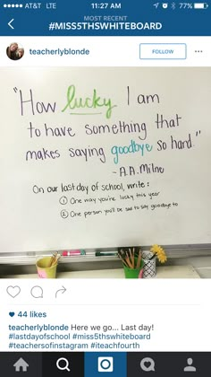 a white board with writing on it and flowers in front of the board is shown