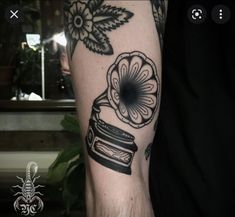 a black and white photo of a person's arm with a tattoo on it