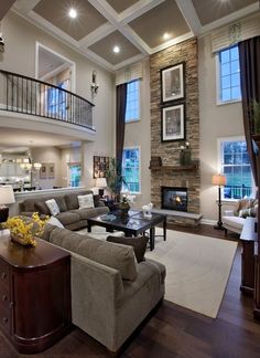 a living room filled with lots of furniture next to a fire place in a house