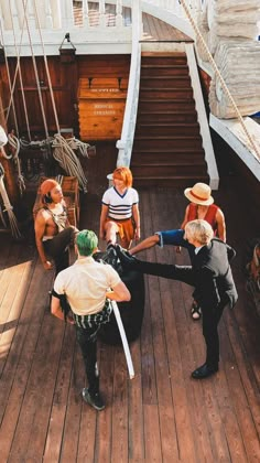 several people on a boat holding onto something with one hand and the other arm extended