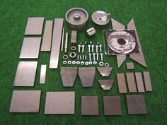 various metal parts laid out on a green surface