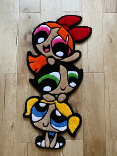 two rugs with cartoon characters on them sitting on the floor next to each other