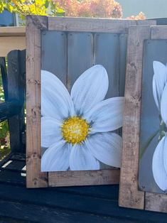 two paintings of white flowers on wooden boards