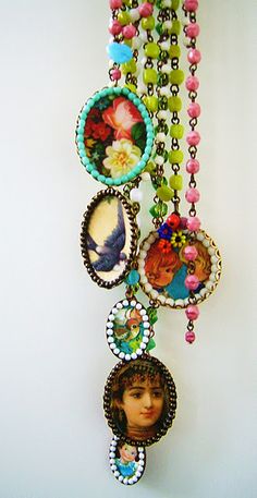 a necklace with pictures and beads hanging from it