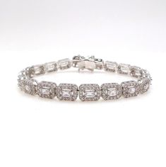 a white gold bracelet with baguetts and diamonds on the clasp, set in 18k white gold