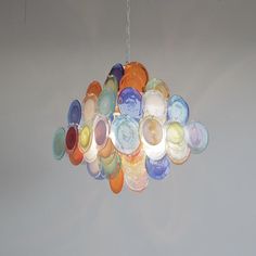 a multicolored glass chandelier hanging from a ceiling