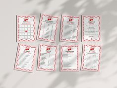 a set of eight red and white wedding seating cards with hearts on the back,