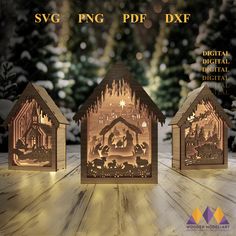 three paper cut nativity scenes are displayed on a wooden table in front of snow - covered trees