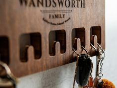 a wooden key holder with several keys hanging from it