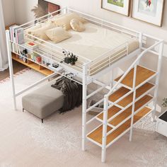 a white loft bed sitting on top of a wooden floor next to a stair case