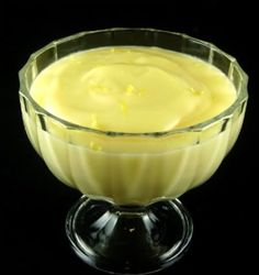 a glass bowl filled with yellow liquid on top of a table