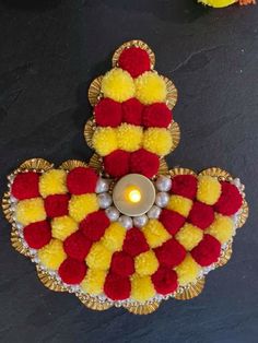 a decorated diya with candles and flowers