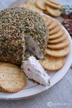 cheese ball with crackers and nuts on a plate