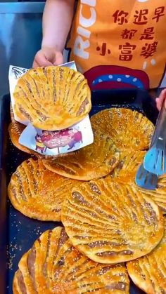 a person cutting up some food on top of a pan