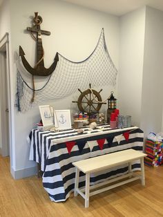 the table is set up for an event with nautical themed decor and decorations on it