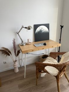 a wooden desk topped with a laptop computer sitting on top of a hard wood floor