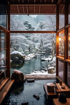 a room filled with lots of snow covered rocks next to a small stream in the middle of