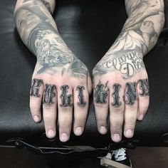 two hands with tattoos and lettering on them