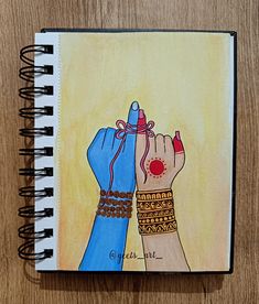 a drawing of two hands holding each other on top of a wooden table next to a spiral notebook