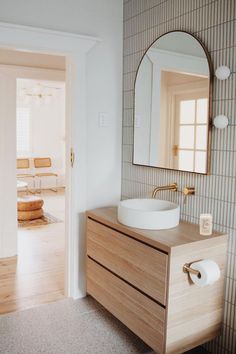 a bathroom with a sink and mirror in it