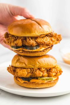 two chicken sandwiches stacked on top of each other