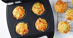 several muffins being cooked in an electric griddle