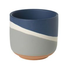 a blue and white bowl with stripes on the bottom, sitting in front of a white background