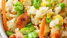 rice with carrots and peas in a white bowl