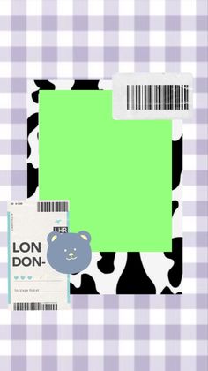 a green and black teddy bear on a checkered tablecloth with a barcode