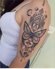 a woman's arm with a tattoo on it that has an image of a butterfly