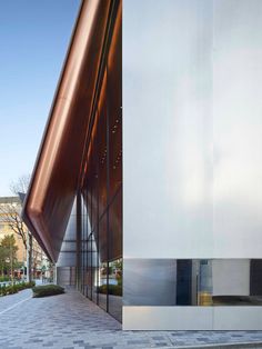 the entrance to an office building with a large metal structure