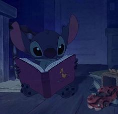 stitch is reading a book while sitting on the floor