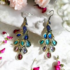 I LOVE Peacocks!  These Beautiful Peacock Dangle Earrings are full of sparkly rhinestones.  They a super lightweight with fish hook hangers and rubber backs for security and comfort.  These earrings go with so many different colors.  They are the perfect wardrobe accessory to have in your jewelry box. Faberge Jewelry, Peacock Jewelry, Peacock Earrings, Beautiful Peacock, Wardrobe Accessories, Perfect Wardrobe, Earrings Statement, Peacocks, Pierced Earrings