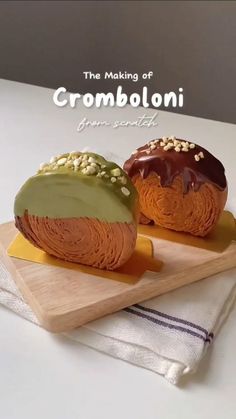 two pastries sitting on top of a cutting board next to each other, with the words crombolonii written above them