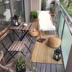 a balcony with chairs, tables and plants on the outside deck area that is covered in wicker rugs