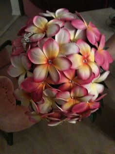 a woman holding a bouquet of pink and white flowers