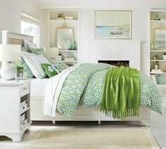 a bedroom with white walls and green accents