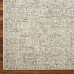 an area rug with wood flooring in the middle and a white background on top