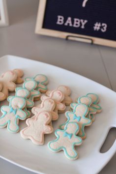 some cookies are on a white plate near a sign