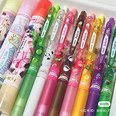 many different colored pens are lined up in a row on top of the other ones