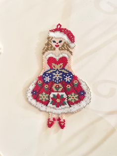 an ornament made to look like a girl in a dress