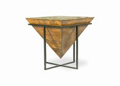 a wooden table with metal legs and an upside down triangle on it's side