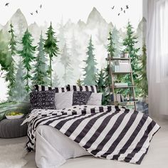 a bed room with a neatly made bed and trees on the wall