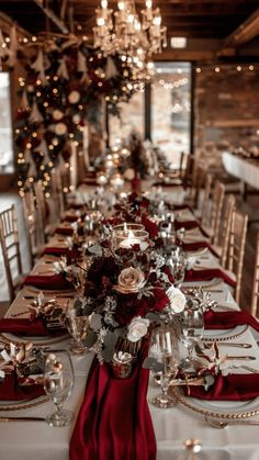 a long table is set with red napkins and place settings